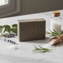 One With Nature Dead Sea Mud Soap bar on marble surface with botanical accents