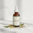 Orange Naturals Homeopathic Appetite for Kids 100ml bottle on marble surface with botanical accents