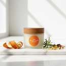 Orange Acne Control Cream on marble surface with botanical accents