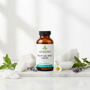 Genestra Multi Cal Mag Liquid supplement bottle on marble surface with botanical accents