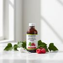 Genestra English Ivy Cold and Cough Syrup Raspberry bottle on marble surface with ivy and raspberry accents