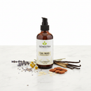Genestra Cal Mag Vanilla Liquid+ supplement bottle on marble surface with vanilla bean and botanical accents