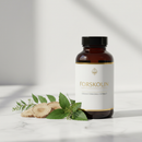 Herbal Slim Forskolin supplement bottle on marble surface with coleus root botanicals
