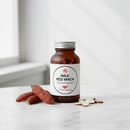 Inka Red Maca 90 capsules bottle on white marble surface with dried maca root accents