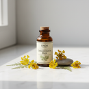 Unda Chelidonium Plex amber bottle on marble with greater celandine botanical accents