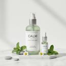 Genestra Cal Mag Liquid Mint supplement bottle on white marble surface with fresh mint botanical accents