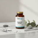 CanPrev Healthy Bones supplement bottle on marble surface with botanical accents