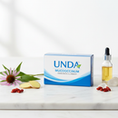 Unda Mucococcinum homeopathic flu remedy on marble surface with botanical accents