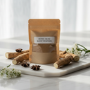Dong Quai Root Powder in kraft bag on marble surface with botanical accents