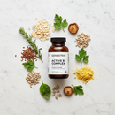Genestra Active B Complex vitamin B supplement bottle on marble surface with grains and botanical accents