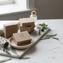 Living Clay Bar Soap Unscented on marble surface with botanical accents
