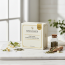 Uncle Lee's Organic Chinese White Tea 18 bags on marble surface with botanical accents
