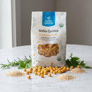 GoGo Quinoa Chickpea Fusilli 227g bag with golden chickpeas and quinoa grains on marble surface