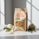 GoGo Quinoa Organic Cauliflower Fusilli 227g bag with fresh cauliflower and quinoa accents on marble surface