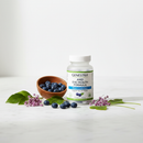 Genestra AMD Eye Health Formula supplement bottle on marble surface with bilberry accents