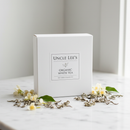 Uncle Lee's Organic White Tea 100 bags on marble surface with dried white tea buds