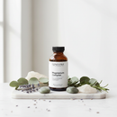 Genestra Magnesium Complex Liquid supplement bottle on marble surface with botanical accents