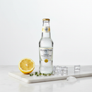 Fever-Tree Indian Tonic Water 500mL glass bottle with lemon and thyme on white marble