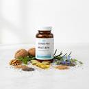 Genestra Multi EFA essential fatty acids supplement bottle on marble surface with walnuts and chia seeds botanical accents