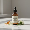100mL amber dropper bottle of Orange Allergy Relief Herbal Remedy on marble surface with botanical accents