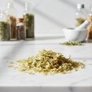 Irish Moss Flakes Cut & Sifted — dried sea moss flakes on white marble surface