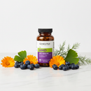 Genestra AMD eye health supplement bottle on marble surface with blueberries and marigold botanical accents