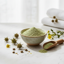 Goksura Powder in a ceramic bowl on white marble with botanical accents