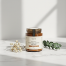 Manuka Health Manuka Honey Bronze 250g jar on white marble surface with botanical accents