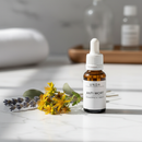 Unda Anti Wort Drops amber bottle on marble with St. John's Wort botanicals