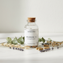 Genestra Selenium + E supplement bottle on marble surface with botanical accents