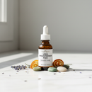 Unda Cholesterinum Plex amber bottle on marble with botanical accents