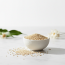 Organic white quinoa in a ceramic apothecary bowl on white marble