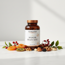 Genestra Maxum Multi Vite 180 caps multivitamin supplement bottle on marble surface with colorful fruit and botanical accents