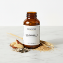 Genestra Selenium + E antioxidant supplement bottle on marble surface with Brazil nuts and sunflower seed botanical accents