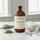 Living Clay Liquid Clay 946mL bottle on marble surface with botanical accents