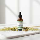 Genestra Oat Combination herbal tincture dropper bottle on marble surface with oatstraw accents