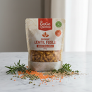 GoGo Quinoa Organic Lentil Fusilli 227g bag with red lentils and quinoa grains on marble surface