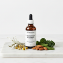Genestra Magnesium Glycinate Liquid supplement bottle on marble surface with botanical accents