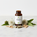 Genestra Herbotox herbal detox supplement bottle on marble surface with milk thistle and dandelion botanical accents