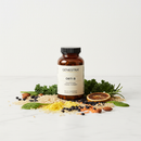 Genestra Orti B orthomolecular B complex supplement bottle on marble surface with grains and leafy green botanical accents