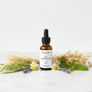 Genestra Oat Combination herbal tincture dropper bottle on marble surface with oat stalks and chamomile botanical accents
